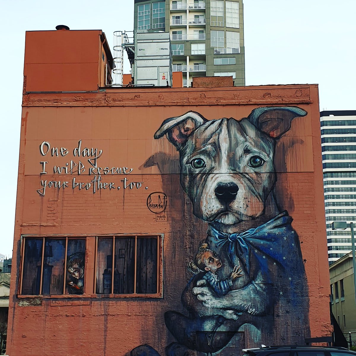 Herakut mural of a pit bull with a superhero cape in downtown Nashville