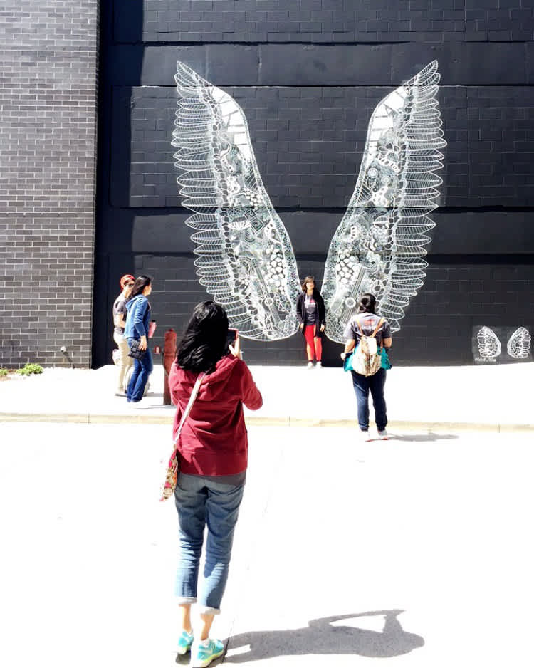 What Lifts You angel wings mural by Kelsey Montague in The Gulch, Nashville